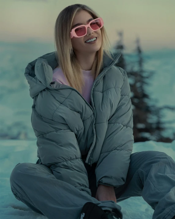 a woman in the snow wearing pink goggles