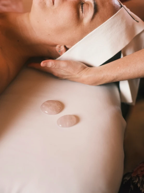 a woman having a facial peel massage on her head