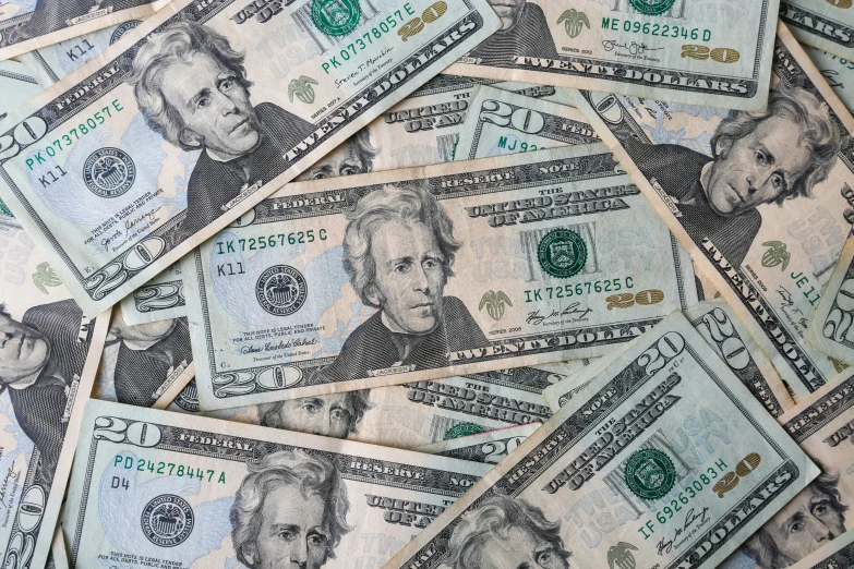 a pile of twenty dollars bills are shown