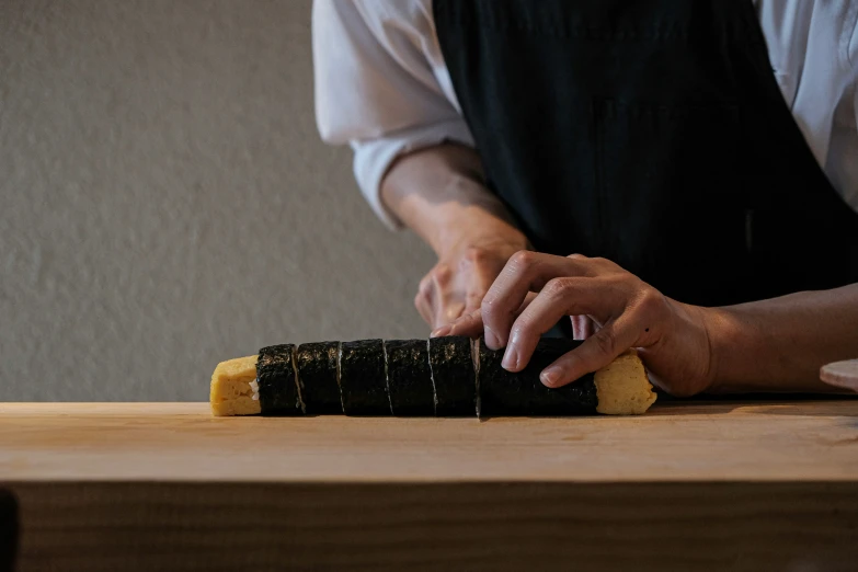 a person working on a sushi in a restaurant