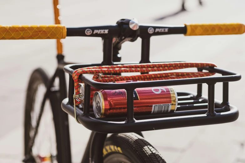 a bicycle with a bicycle rack with 2 rolls of yarn