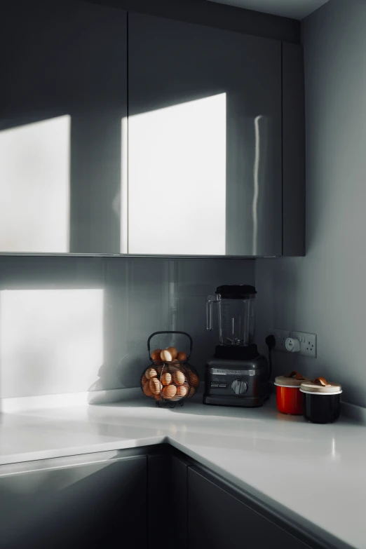 an empty kitchen counter with blender, food container and bowl on it