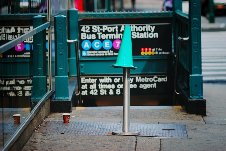 a blue street post sitting by the curb