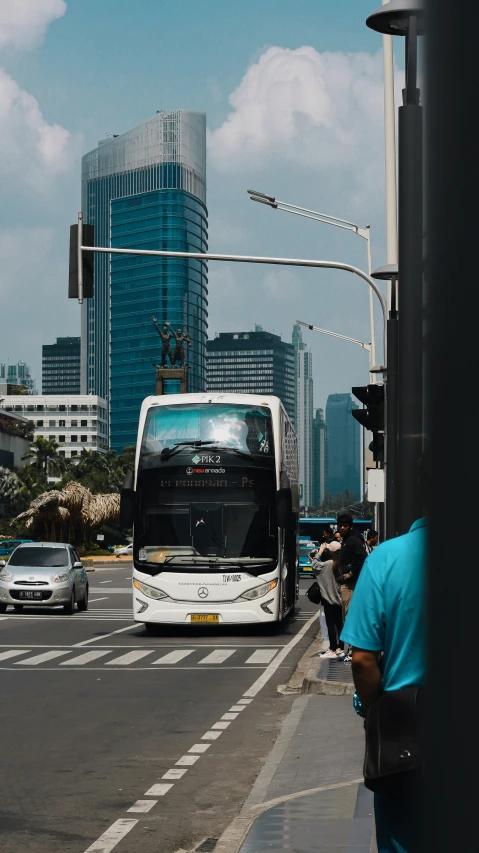 a city street with many cars and a white bus