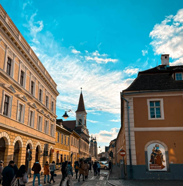 people are walking down the street in front of a building