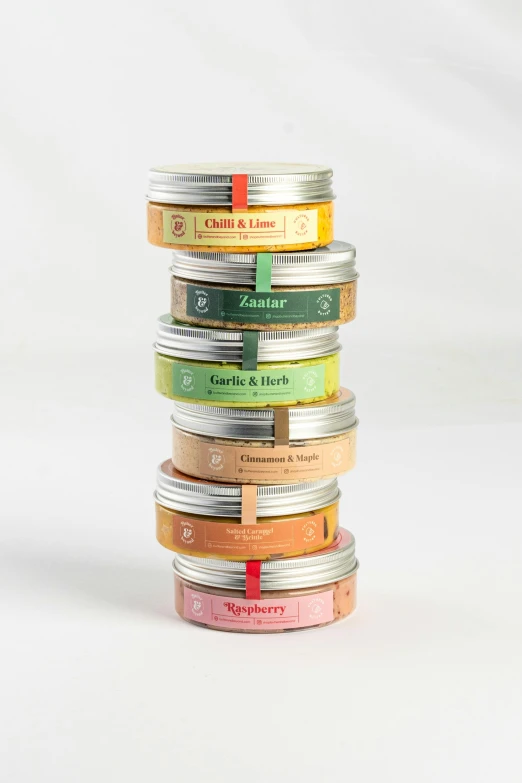 a stack of colorful colored tins with labels on them