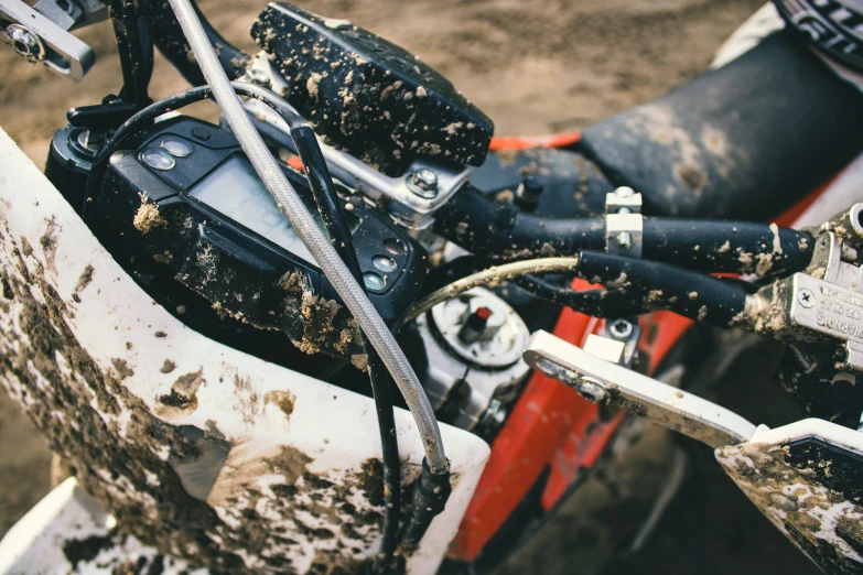 a motocross bike with mud and rusty paint