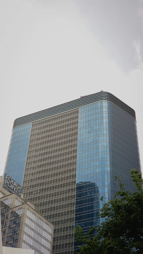 a very tall building with skyscrs and trees