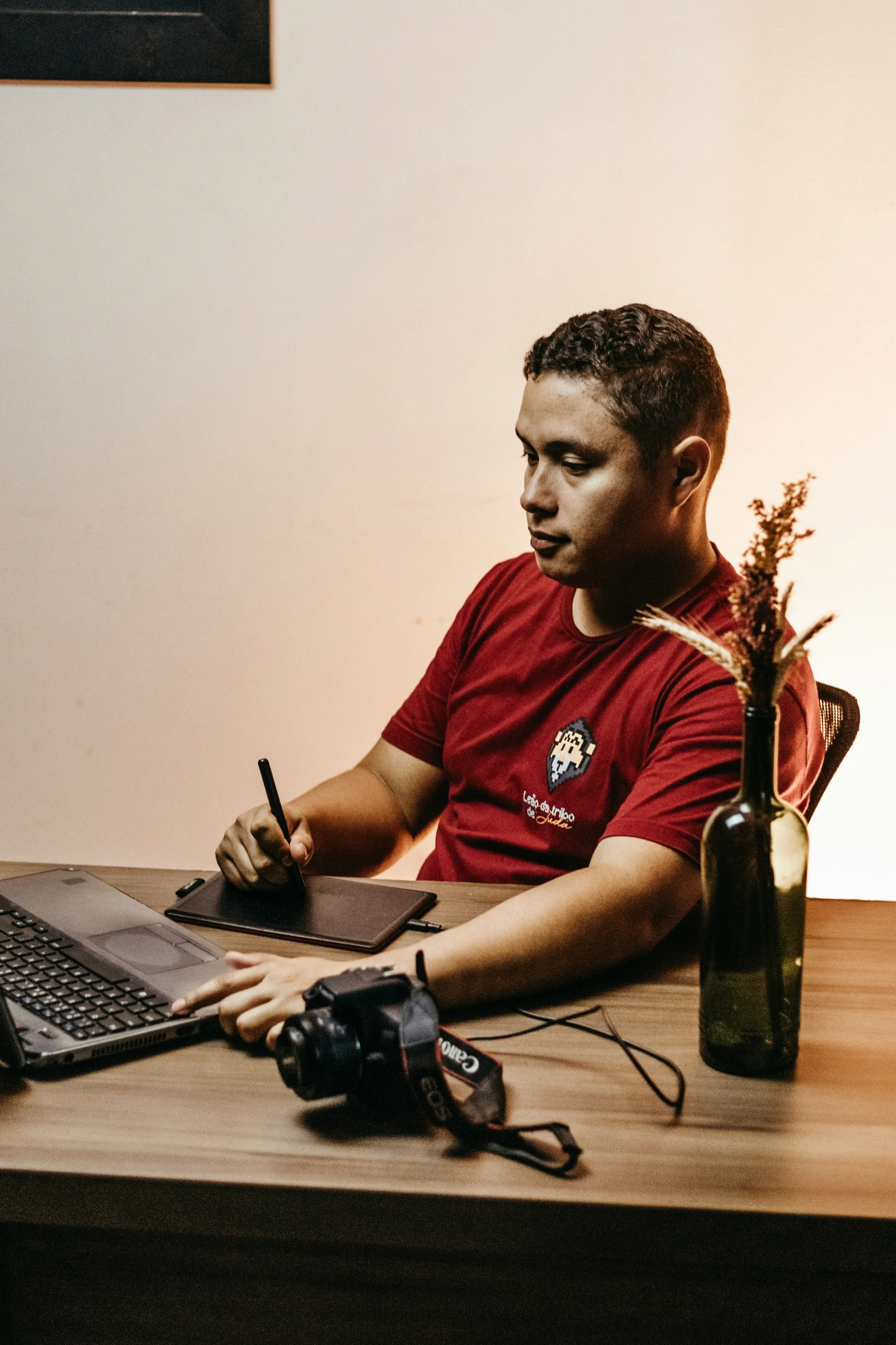 man sitting at desk working on a laptop computer