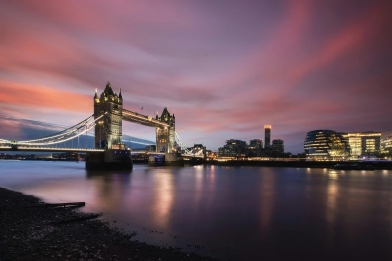 tower bridge in london with lights on at night