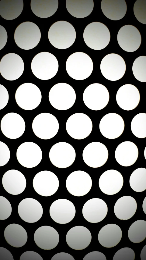 a pattern with circles on black paper