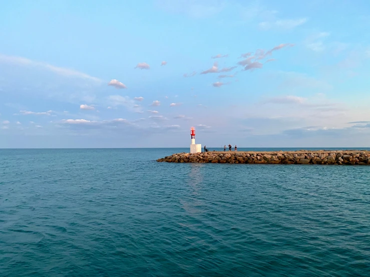 lighthouse in the middle of a body of water