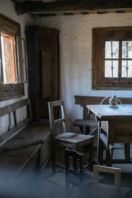 a small table with chairs sits in a room