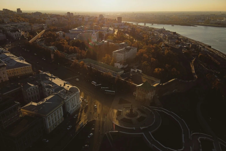 an aerial view of the city and lake at sunset