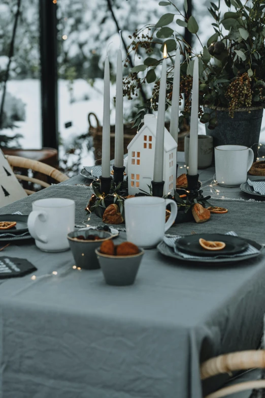 a table set up for christmas with coffee cups