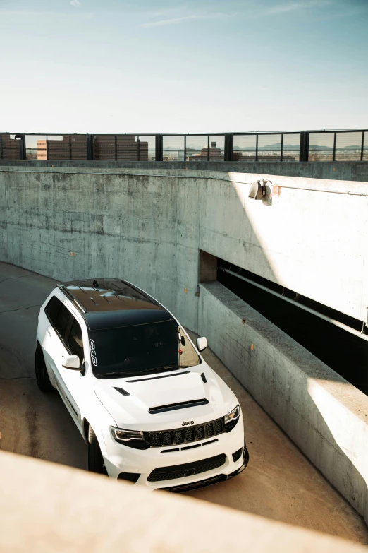 a car parked in the back of a garage next to a cement wall