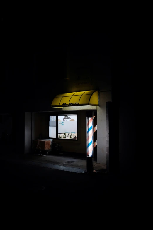 a lit up storefront at night with street lights shining on