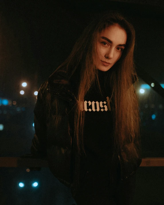 a woman is standing at night on the rooftop