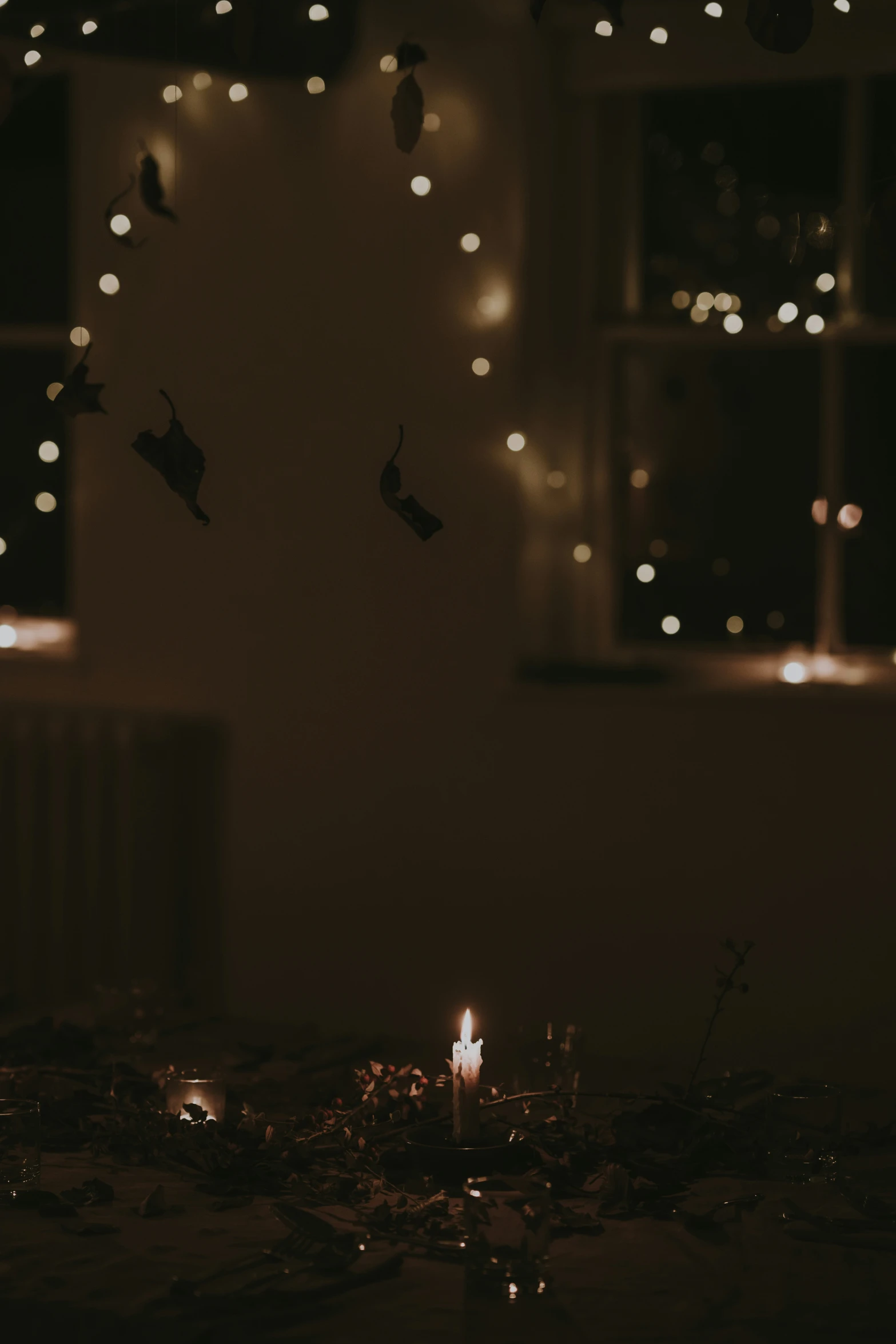 a candle and some lights are glowing in the dark