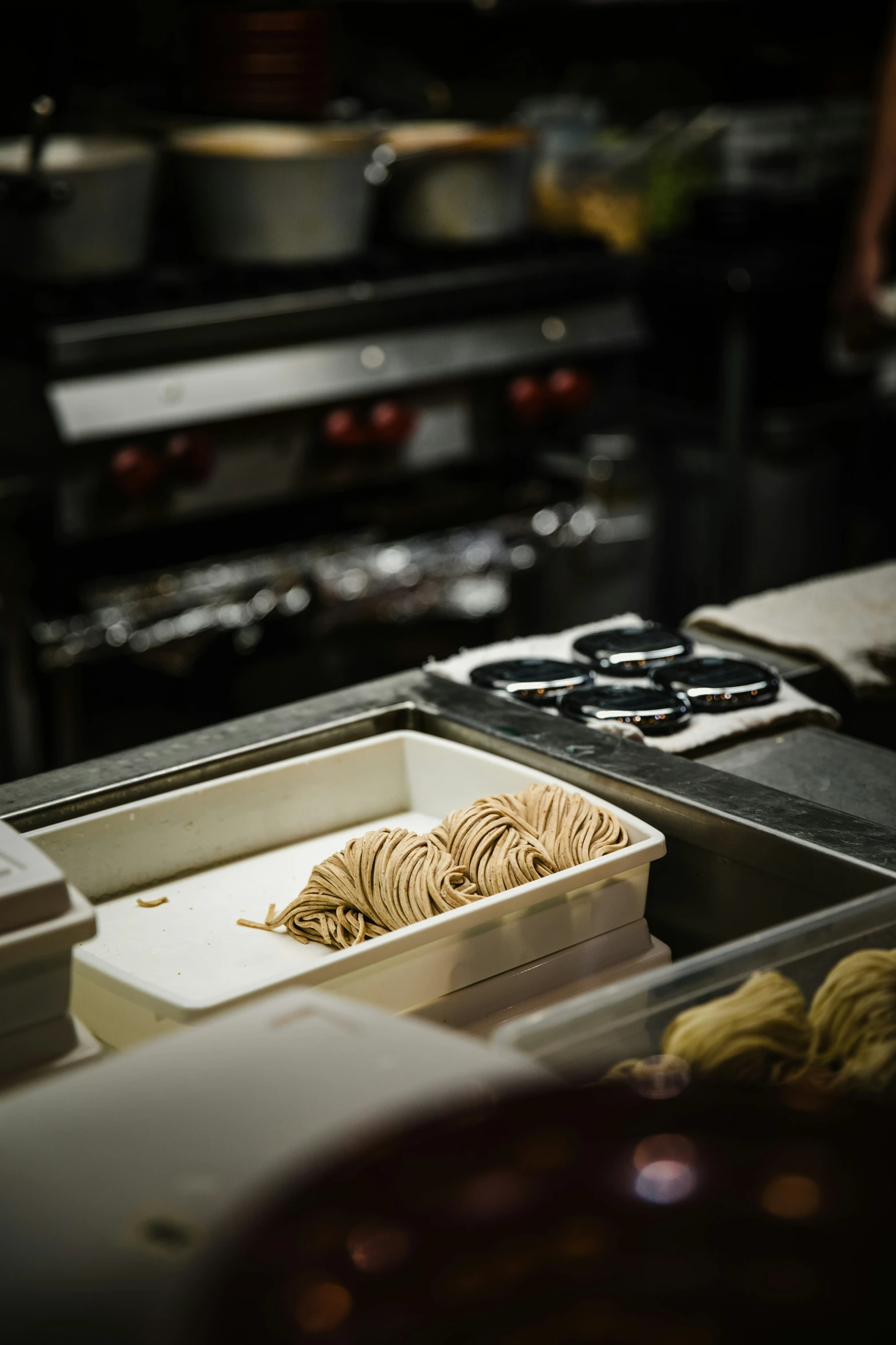 two containers and a box of noodles on a counter top