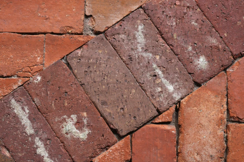 a brick sidewalk with white chippings has faded paint