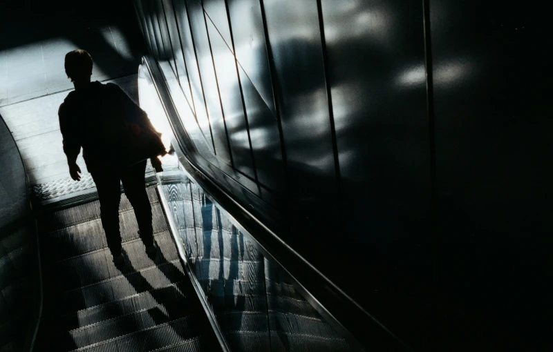 a person is walking up an escalator on a sunny day