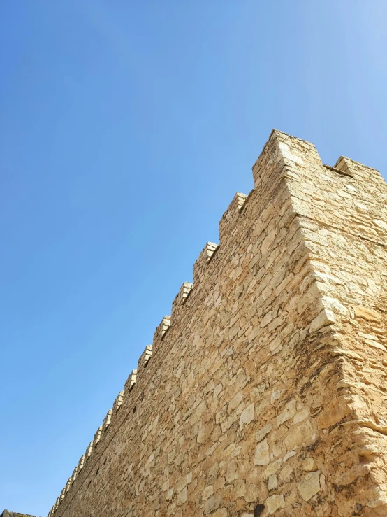 a tall brick building sitting on top of a hill