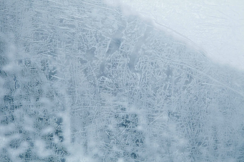 snow flakes are falling off of a window