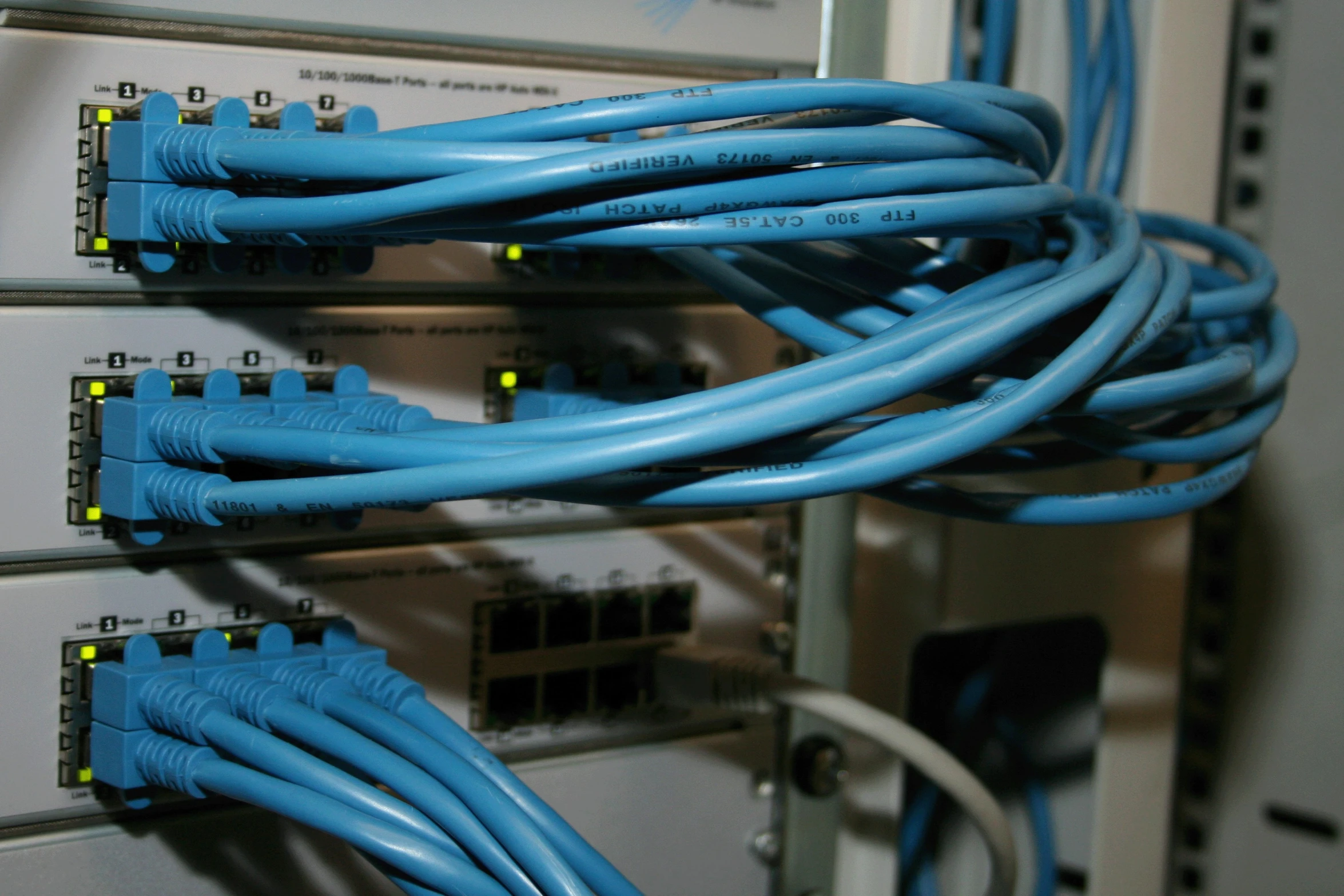 blue wires are connected to a server in a switch room