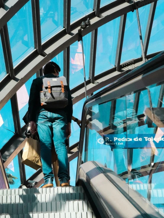 a man is climbing up the escalator in a station