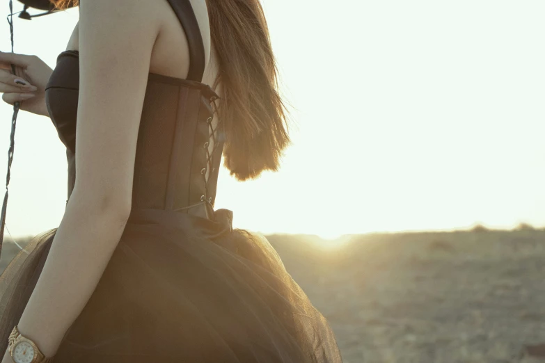 a woman is standing on the beach carrying a purse