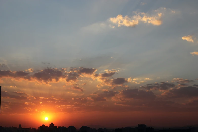 a sunset view of some skyscrs from across the water