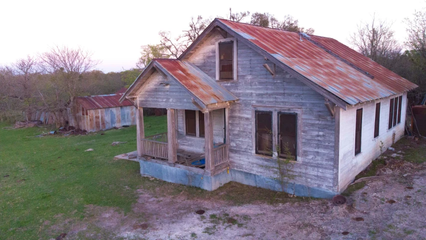 an old run down building in the woods