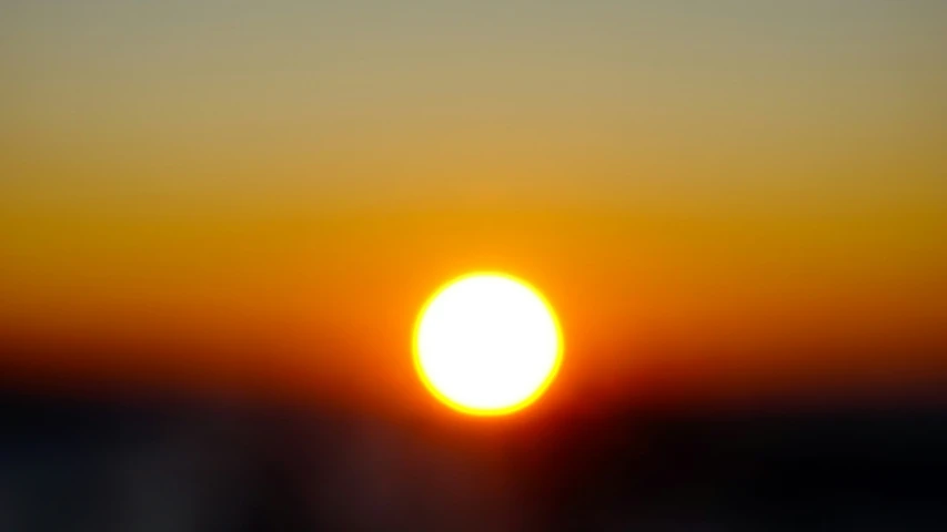 a bright sun is seen over the horizon