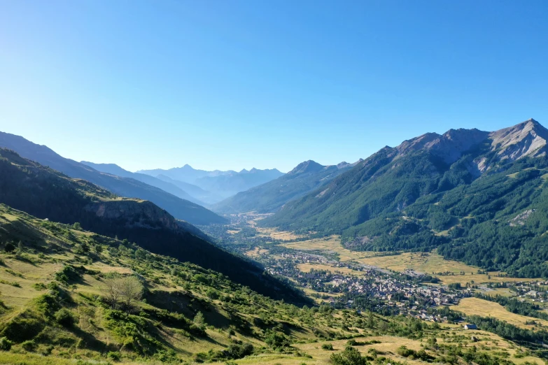 a view from the mountain top shows a valley and town