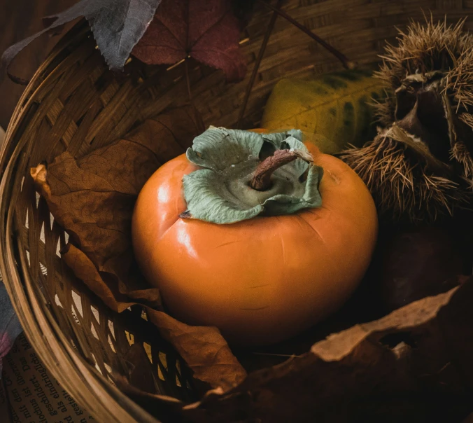 an orange in the basket with another rotten fruit