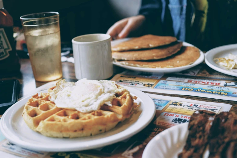 two waffles with a large fried egg on them