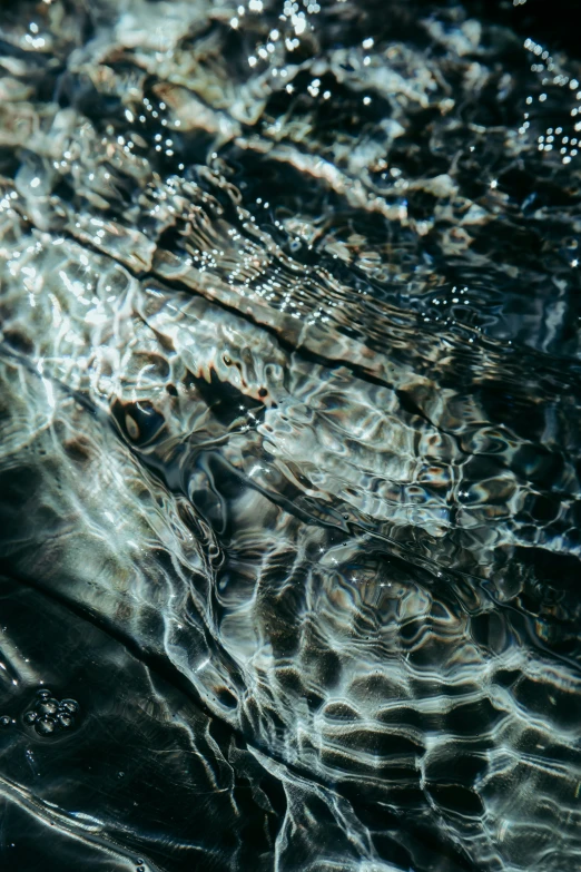 a close up of water reflecting its bubbles