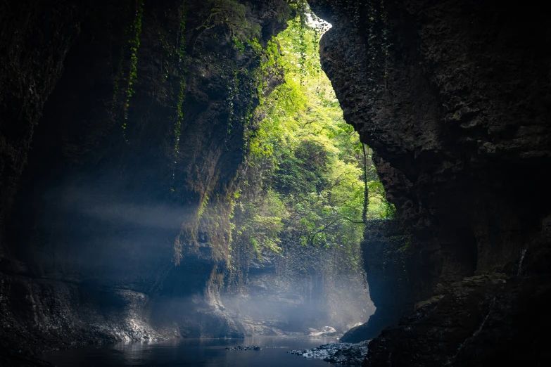 a waterfall surrounded by water flowing from it to the ground