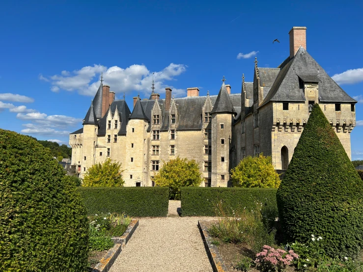 an old castle with lush green vegetation in front of it