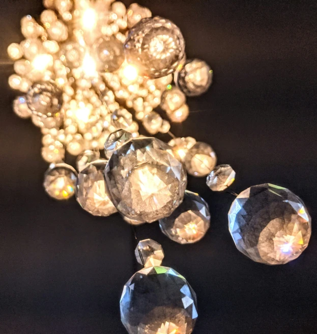 beads on display in a black room with lights coming from them