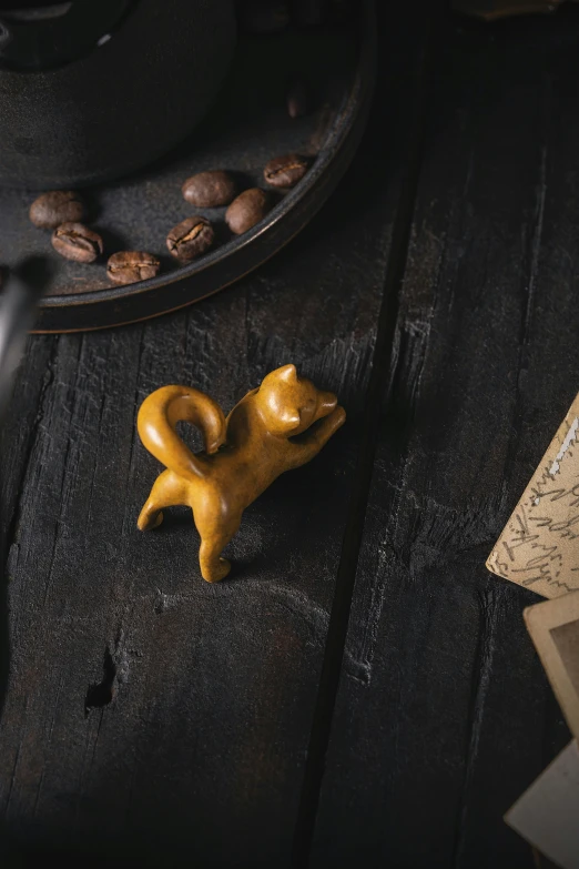 a cupcake shaped like a dog sits on the table with coffee beans