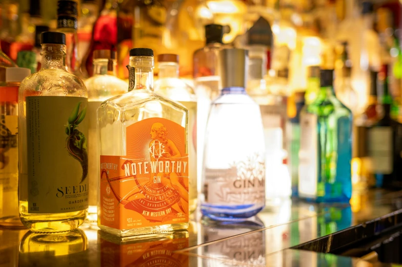 a group of bottles of different alcohol sitting on top of a counter