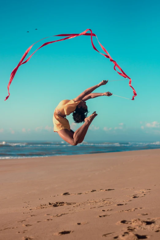 a girl is flying her kite on the beach