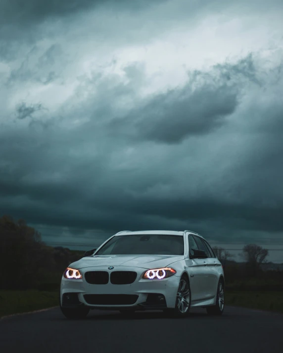 the front view of a car is pictured on a road