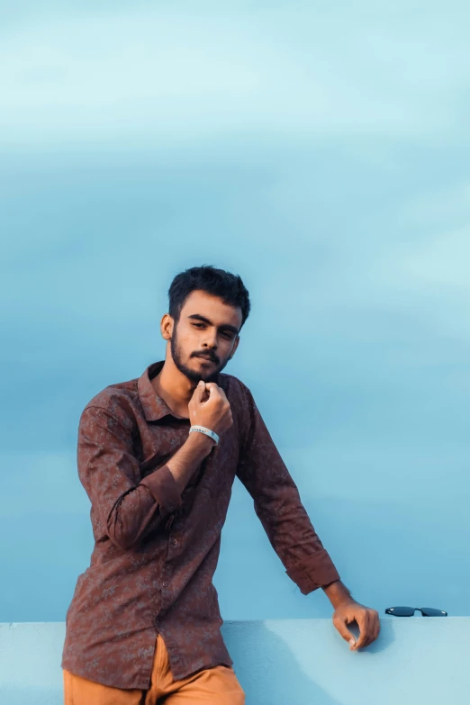 the man is posing for a picture in his shirt