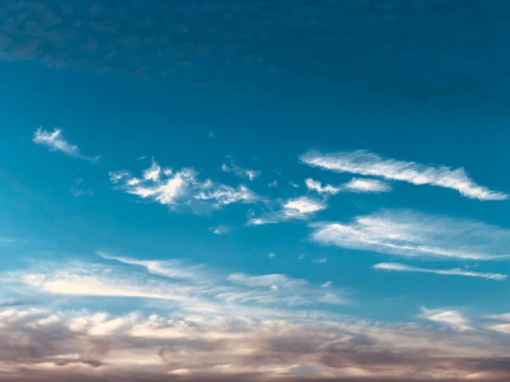 an airplane flying through the sky near the ocean