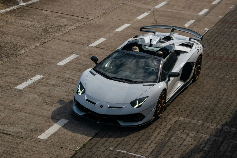 a close up of a sports car on a road