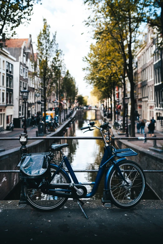 a small motorcycle parked beside water in the street