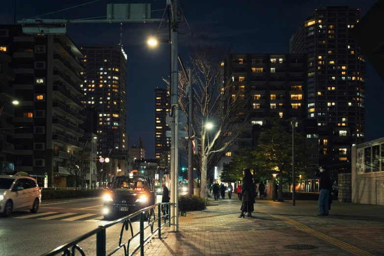 a street in the city with several cars driving